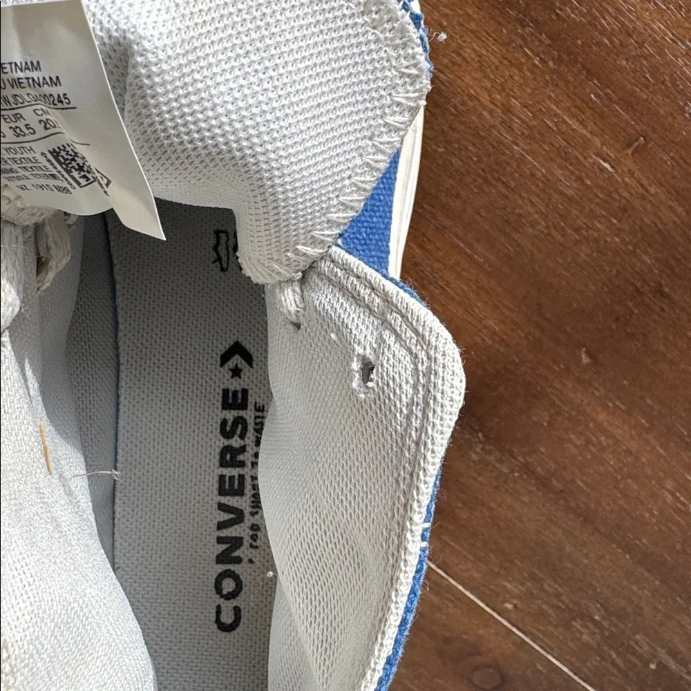 Size 2 Converse Chuck Taylor All Star Sneakers on blue